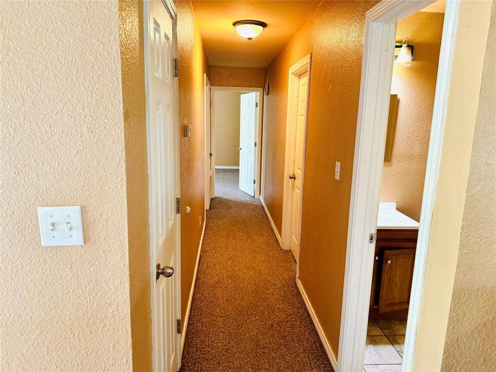 12875 Westover Lane, Anna, TX 75409 Hallway with textured walls and carpet flooring