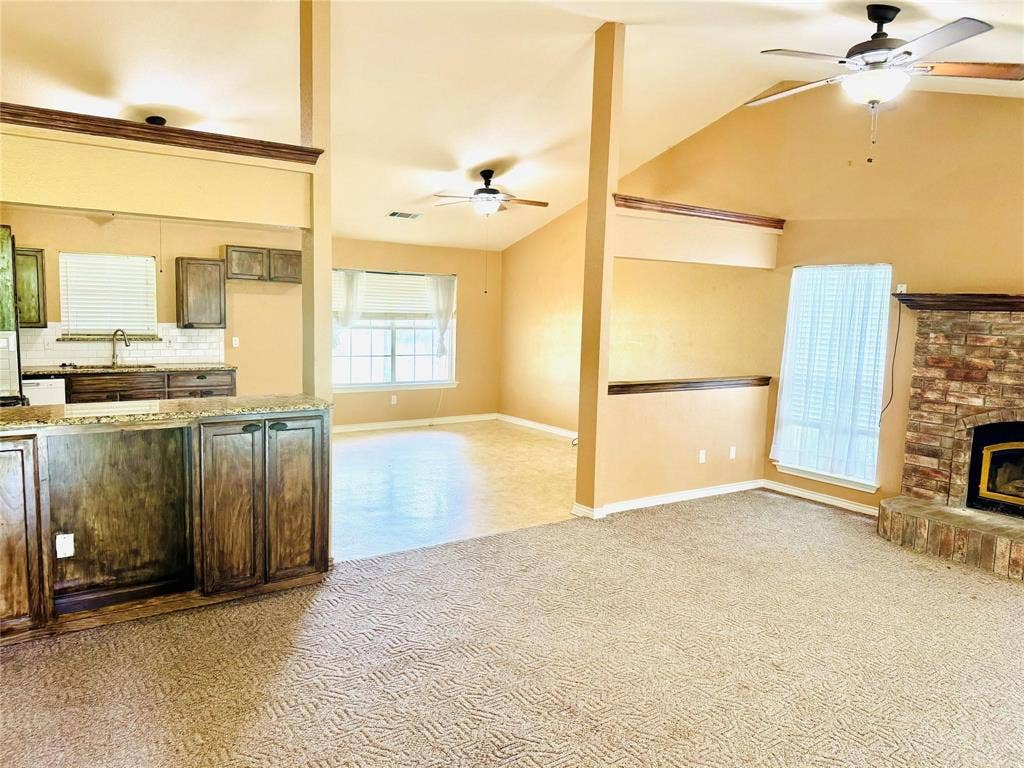 12875 Westover Lane, Anna, TX 75409 Kitchen with wood-finish cabinetry, granite-style countertops, and a tile backsplash