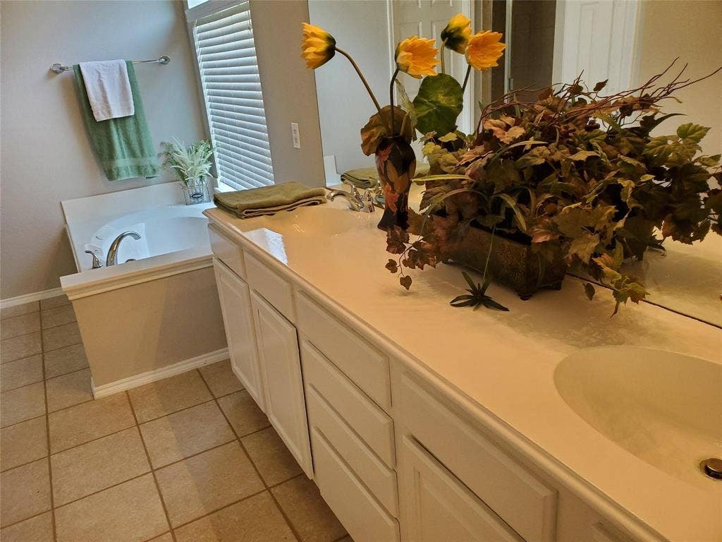2077 Sleepy Hollow Trail, Frisco, TX 75033 Bathroom with tile patterned floors, double sink vanity, and a bathtub