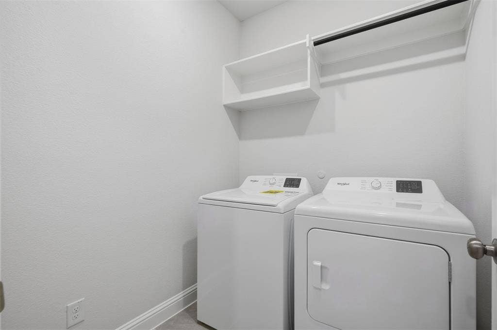 White built-in shelving, integrated hanging rod, and light-toned flooring