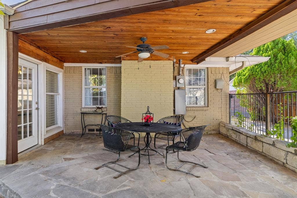 824 Westwood Drive, Richardson, TX 75080 This covered patio is an amazing place to relax or entertain! It features a natural stone floor, wood-plank ceiling, recessed lighting, and a painted brick exterior wall.
