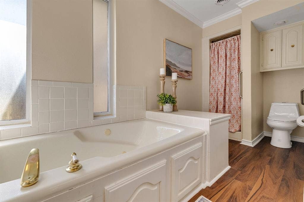 824 Westwood Drive, Richardson, TX 75080 Another view of the primary ensuite bathroom showing the separate shower and toilet area.
