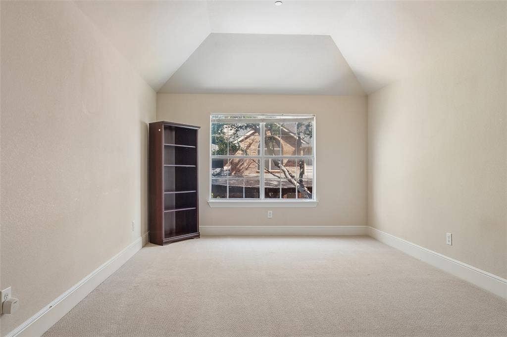 Recessed ceiling with an angled design, light neutral wall paint, and plush carpeting
