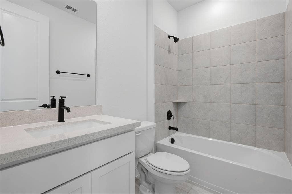 White vanity with an integrated rectangular sink and light-toned countertop