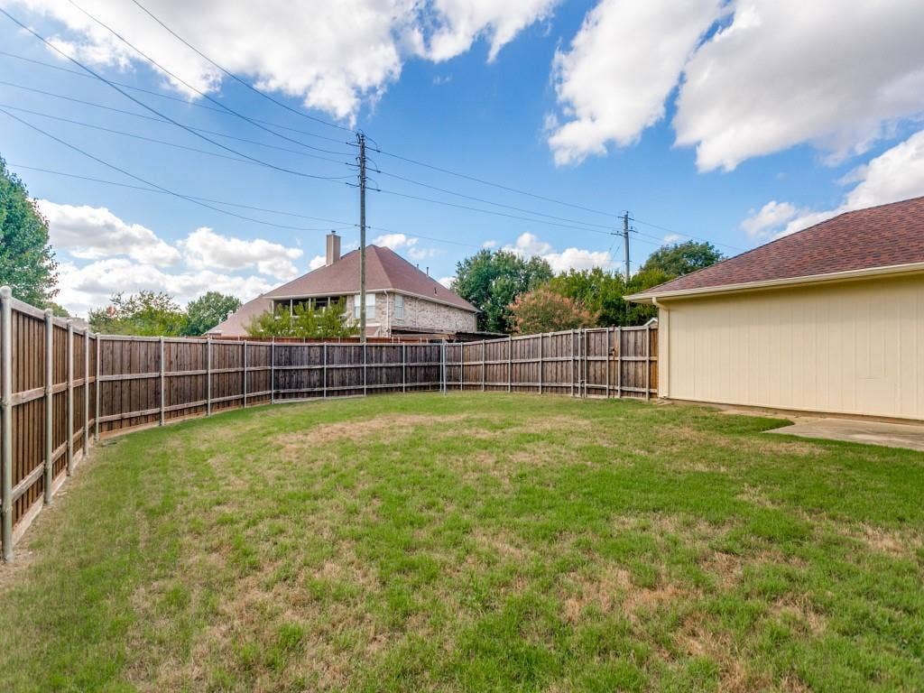 714 Bluebonnet Drive, Allen, TX 75002 Fenced backyard featuring a grass lawn, patio, and wood privacy fencing