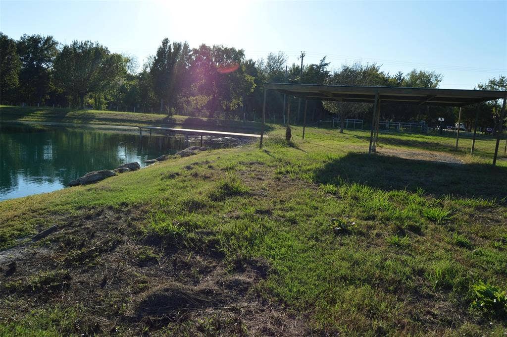 3345 County Road 1125, Farmersville, TX 75442 Pond view with covered area canopy and carport