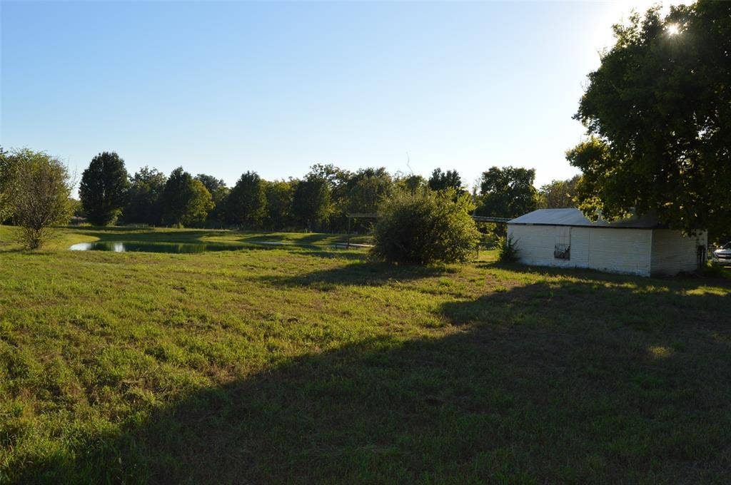 3345 County Road 1125, Farmersville, TX 75442 Looking at garage/shop with pond in view