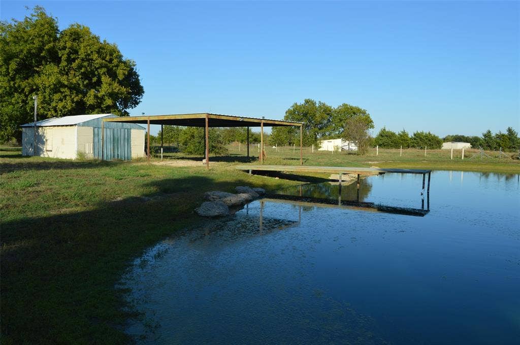 3345 County Road 1125, Farmersville, TX 75442 Looking at garage/shop, carport and pond with dock