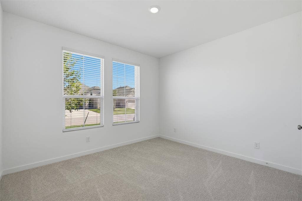 7117 Black Cherry Lane, McKinney, TX 75071 Neutral wall color, recessed lighting, double windows with blinds, and light-toned carpet flooring