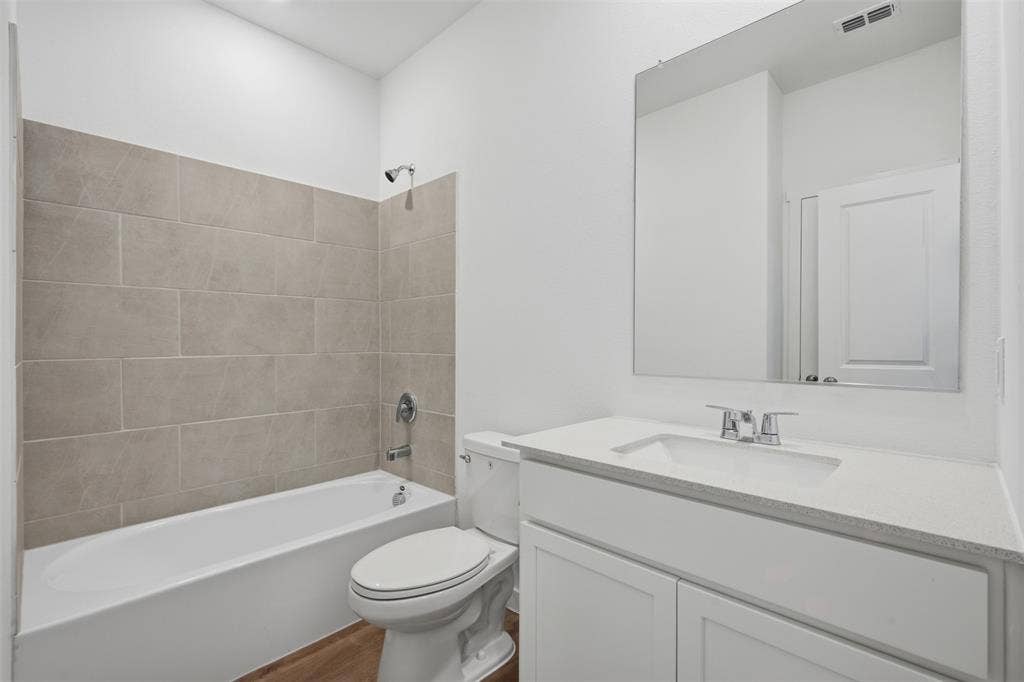 7117 Black Cherry Lane, McKinney, TX 75071 White vanity with a solid surface countertop, undermount sink, and chrome faucet