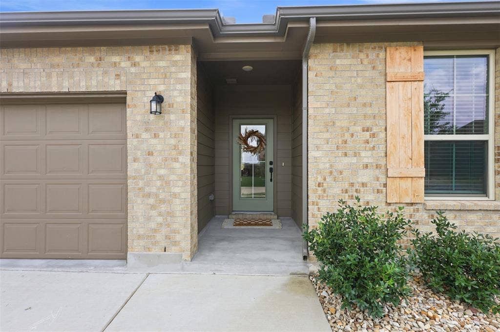 Front Porch with a happy sage green door.