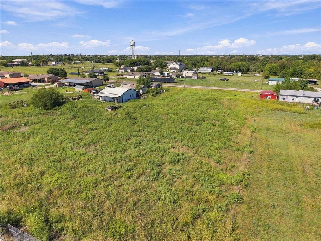 276 Winding River Circle, Farmersville, TX 75442 Expansive undeveloped lot featuring varied green vegetation and a partially visible perimeter fence