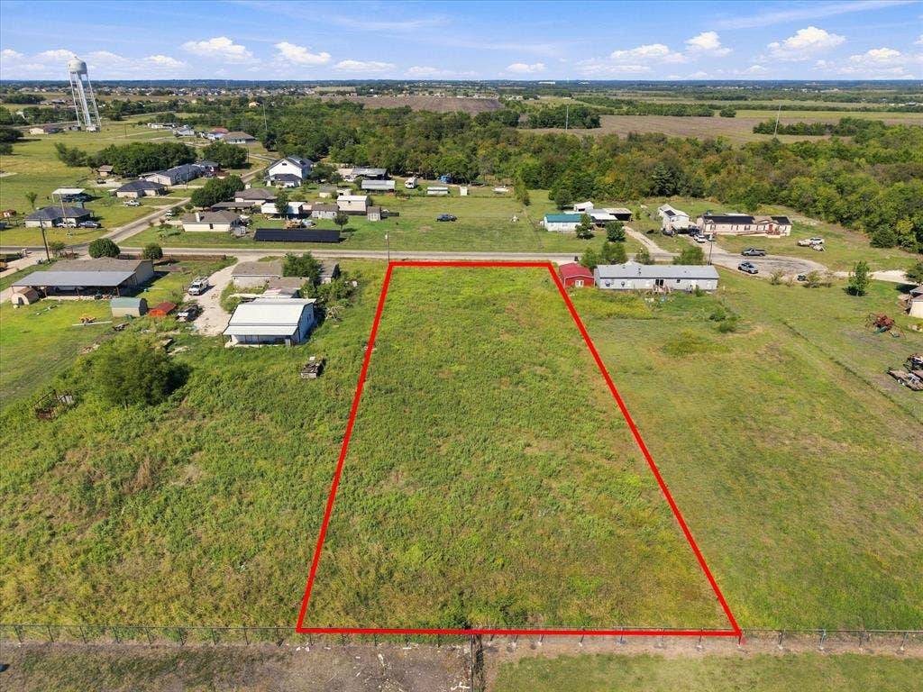 276 Winding River Circle, Farmersville, TX 75442 Expansive undeveloped land parcel with surrounding residential properties, featuring a clear, open expanse