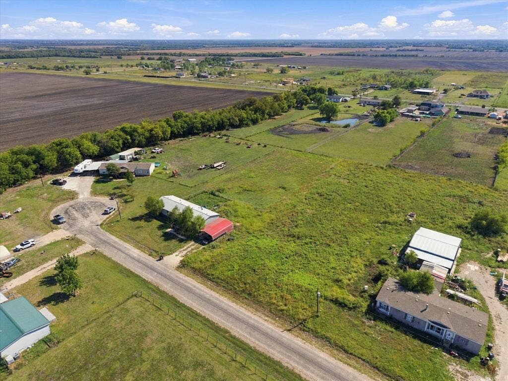 276 Winding River Circle, Farmersville, TX 75442 Expansive rural property featuring a main residence, additional structures, and a pond