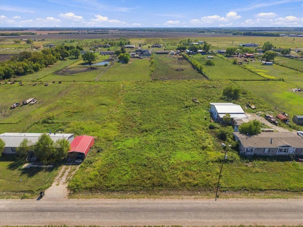 276 Winding River Circle, Farmersville, TX 75442 Expansive land parcel featuring open fields, existing structures, and proximity to a roadway