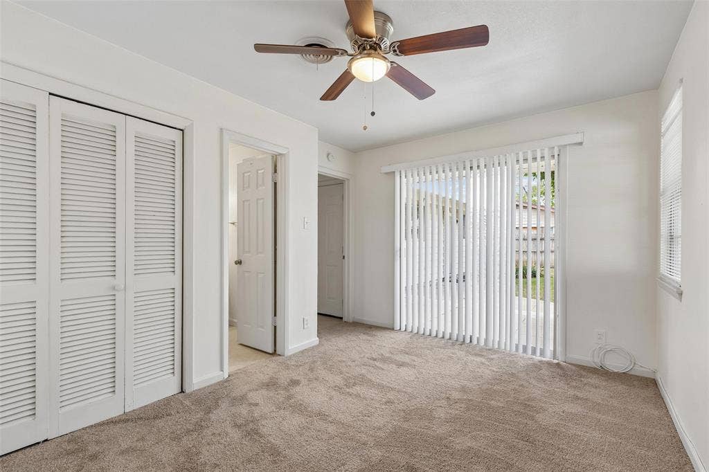 1723 Carlisle Street, Irving, TX 75062 Primary bedroom with sliding glass doors leading to the backyard patio