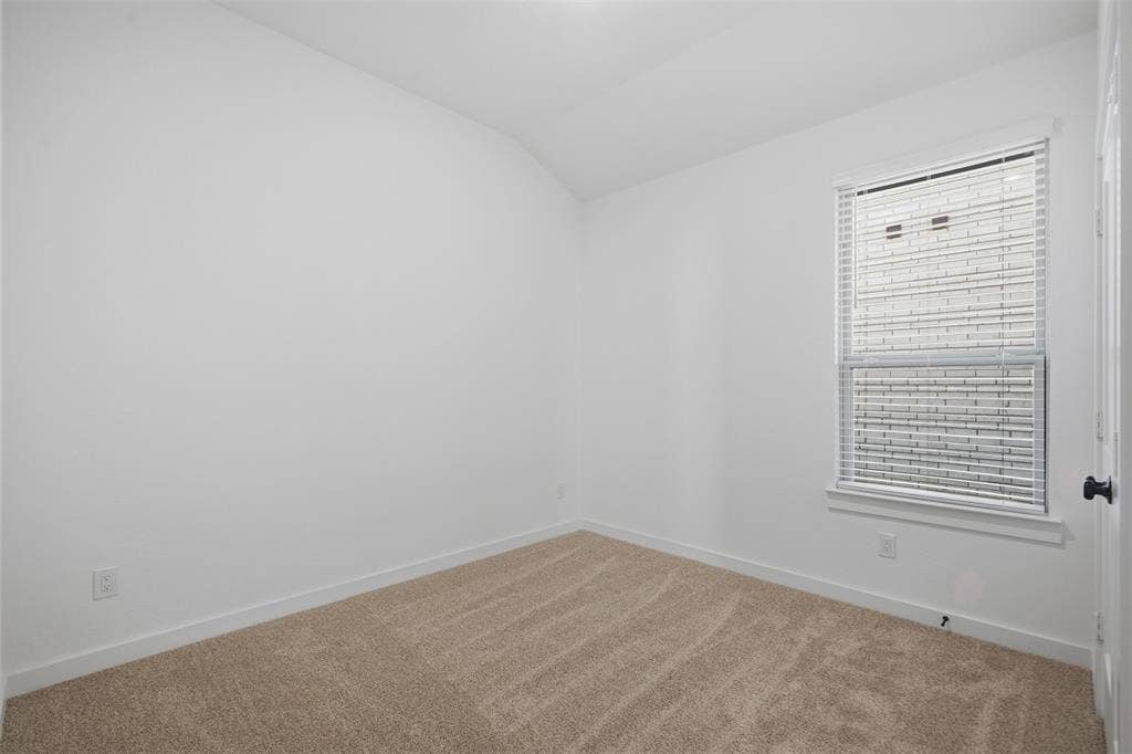 Neutral wall color and carpeted flooring