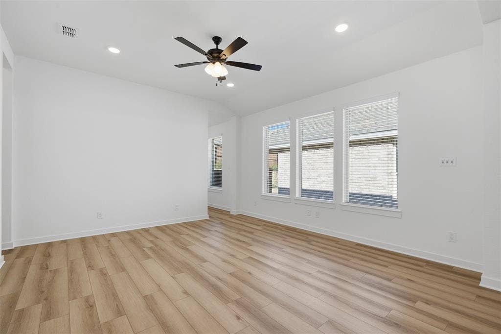 Wood-finish flooring, recessed lighting, and a ceiling fan