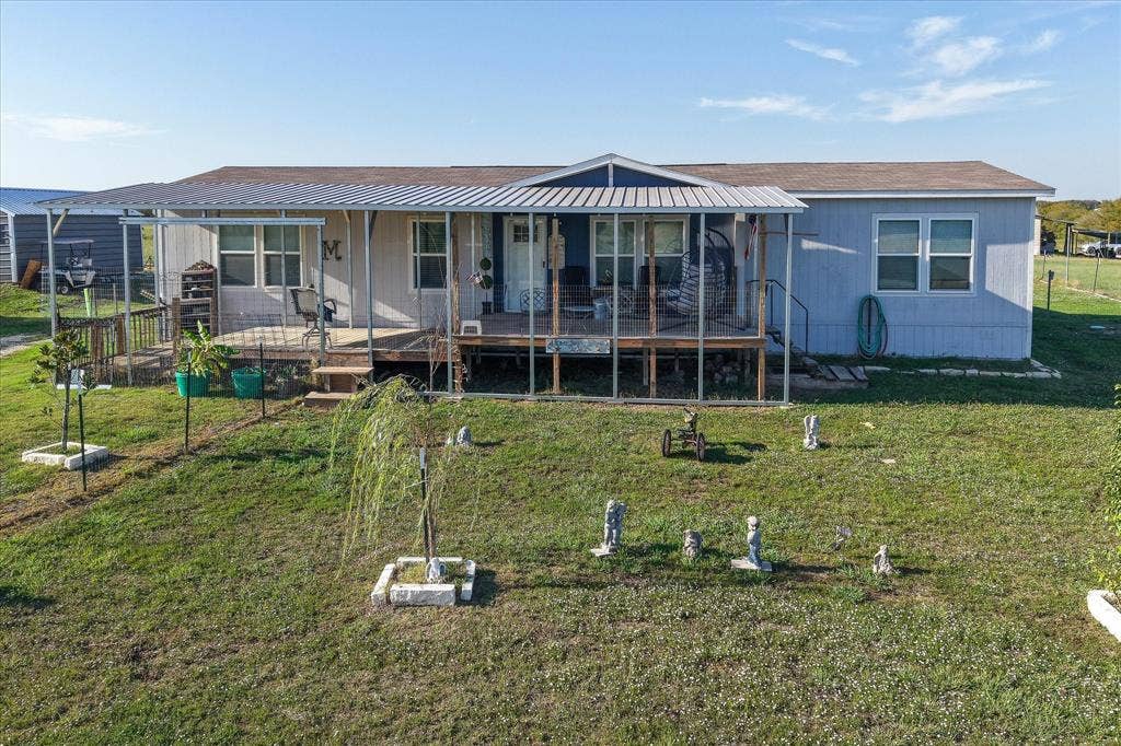 Front yard with large deck and patio.