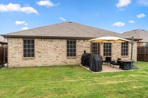 Brick exterior with a gabled roof and rain gutters