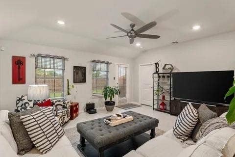 Recessed lighting and ceiling fan complement the vaulted ceiling