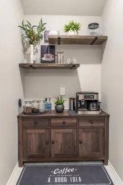 Built-in wood-finish cabinetry with drawers and doors, complemented by two floating wood-finish shelves with metal brackets, set against light-toned walls
