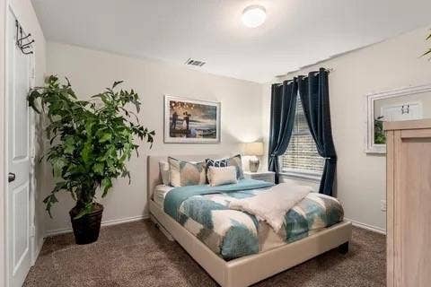 Wall-to-wall carpeting and a ceiling-mounted light fixture
