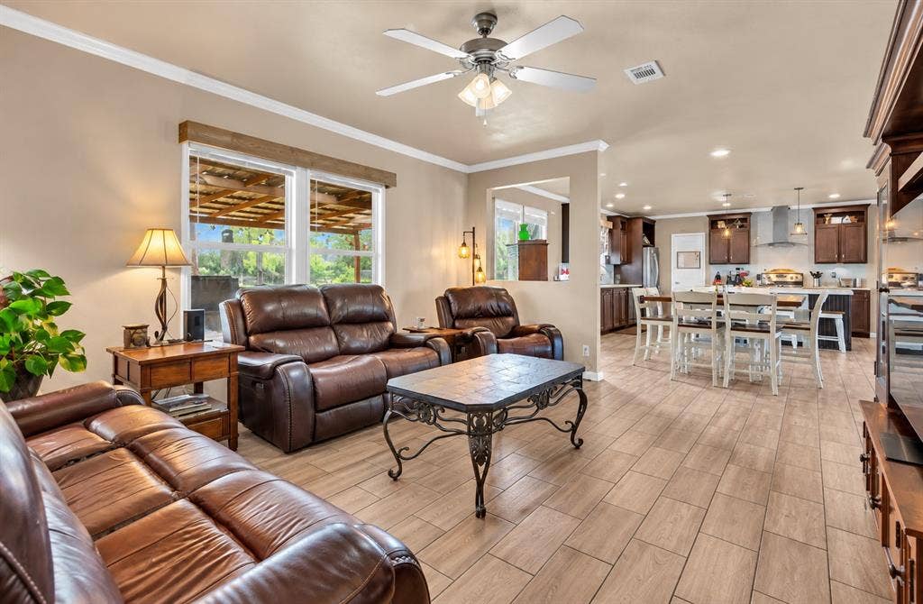 213 River Front Drive, Cedar Creek, TX 78612 Open-concept living space with wood-finish flooring, ceiling fan, and recessed lighting