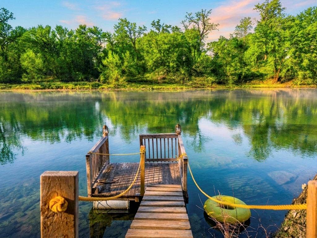 213 River Front Drive, Cedar Creek, TX 78612 Wood-plank dock with a built-in bench, offering direct water access