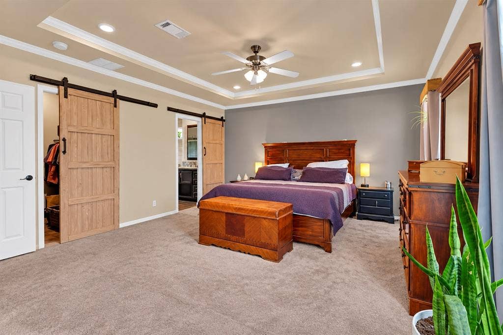 213 River Front Drive, Cedar Creek, TX 78612 Tray ceiling with recessed lighting, ceiling fan, and carpeted flooring