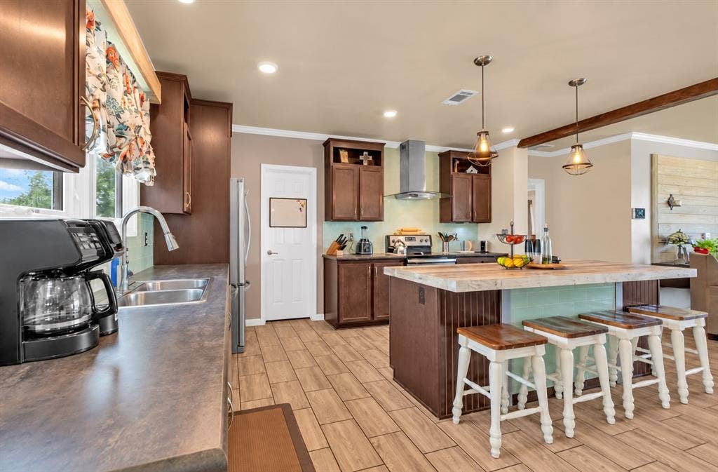 213 River Front Drive, Cedar Creek, TX 78612 Kitchen featuring wood-finish flooring, recessed lighting, and a center island with a light-toned countertop