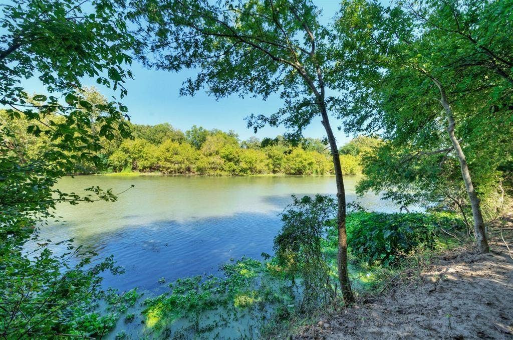 213 River Front Drive, Cedar Creek, TX 78612 Waterfront property with mature trees and lush natural landscaping