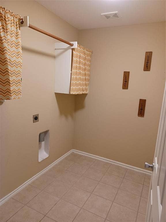 Tile flooring, wall-mounted cabinetry, and a ceiling-mounted light fixture