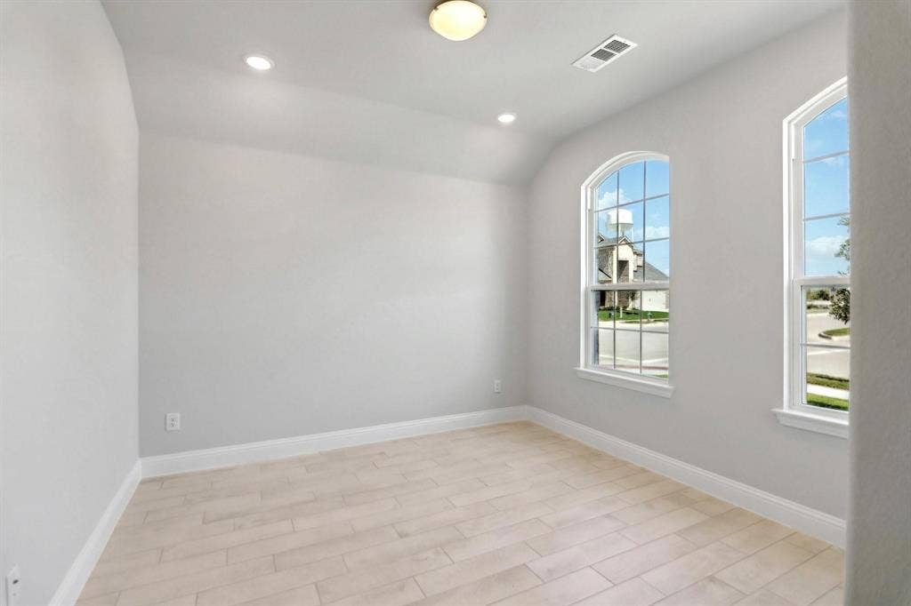 Arched windows, recessed lighting, and a neutral color palette