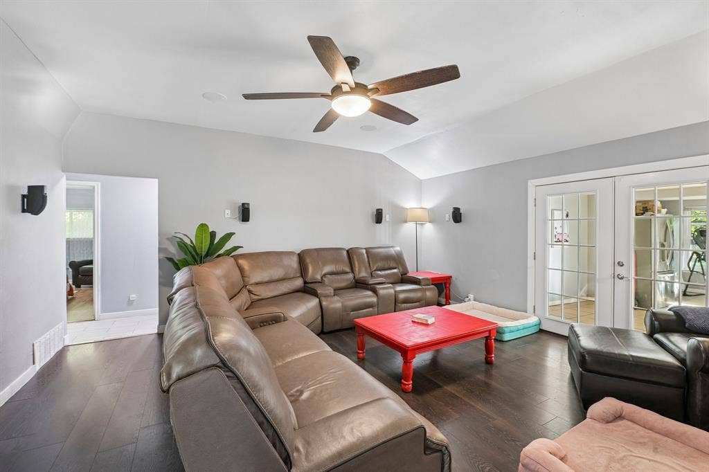 500 Spinner Road, DeSoto, TX 75115 Vaulted ceiling with a ceiling fan, dark wood-finish flooring, light gray wall paint, and double French doors with glass panes