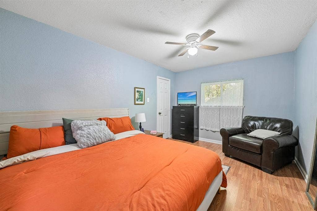 500 Spinner Road, DeSoto, TX 75115 Ceiling fan with integrated lighting, wood-finish flooring, and a window providing natural illumination