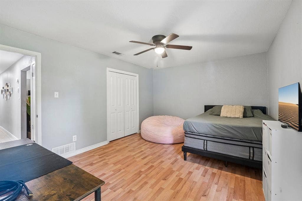 500 Spinner Road, DeSoto, TX 75115 Wood-finish flooring, ceiling fan, and bi-fold closet doors