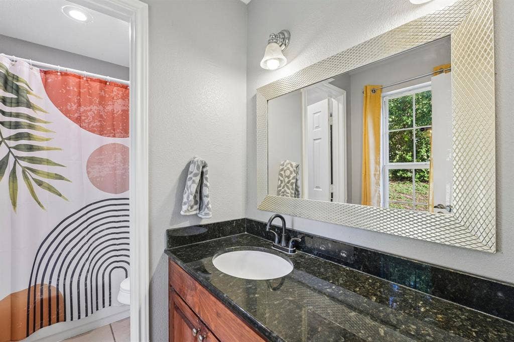 500 Spinner Road, DeSoto, TX 75115 Dark-toned countertop with an integrated sink and a single-handle faucet