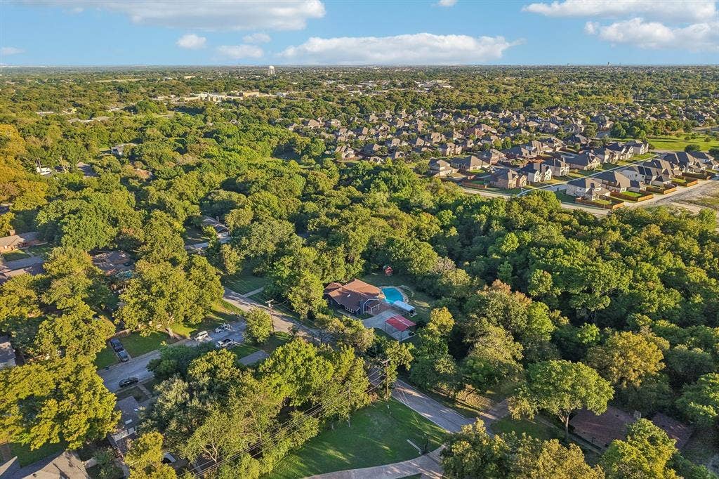 500 Spinner Road, DeSoto, TX 75115 Aerial perspective showcasing dense tree coverage and residential properties