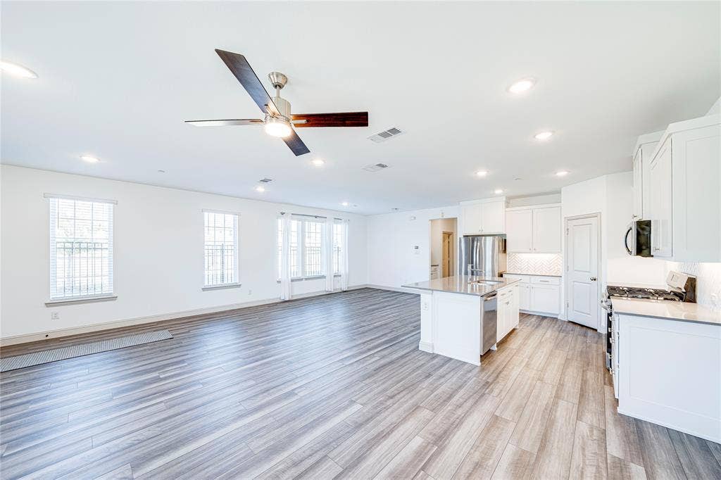 8888 Samara Street, Frisco, TX 75035 Open-concept living space featuring wood-finish flooring, recessed lighting, and a ceiling fan