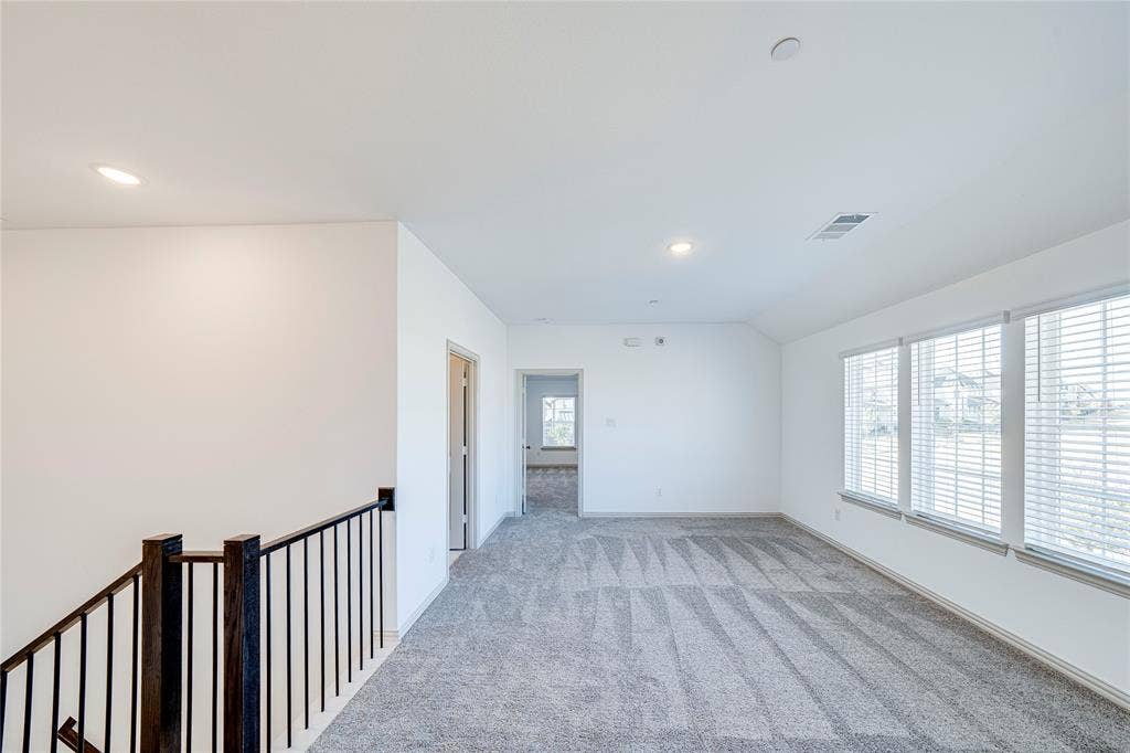 8888 Samara Street, Frisco, TX 75035 Carpeted room with multiple windows, recessed lighting, and a balustrade