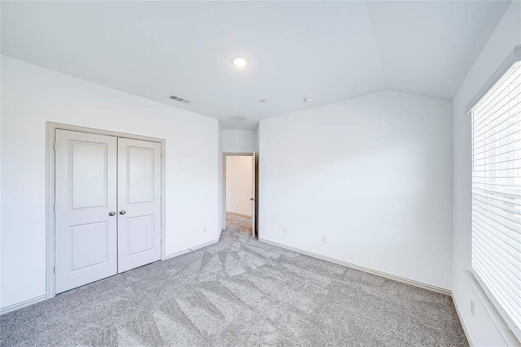 8888 Samara Street, Frisco, TX 75035 Vaulted ceiling, recessed lighting, double panel doors, neutral carpeting, and a window with blinds