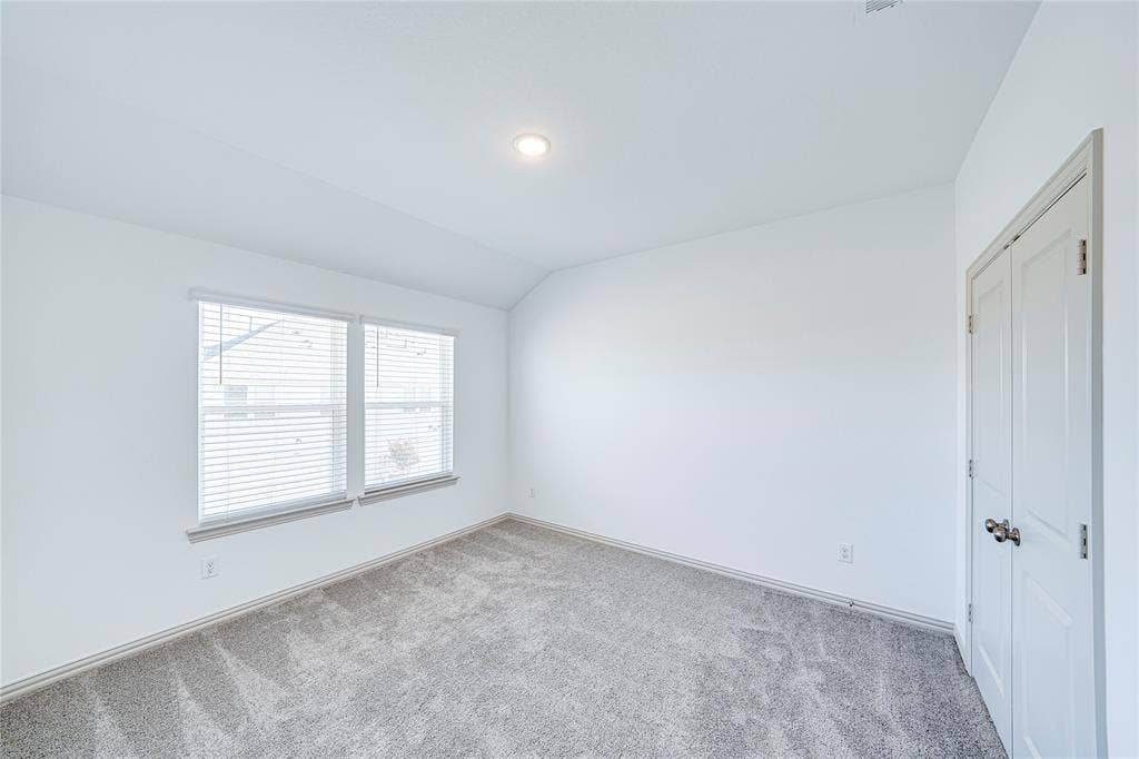 8888 Samara Street, Frisco, TX 75035 White walls, recessed lighting, and a double window with blinds