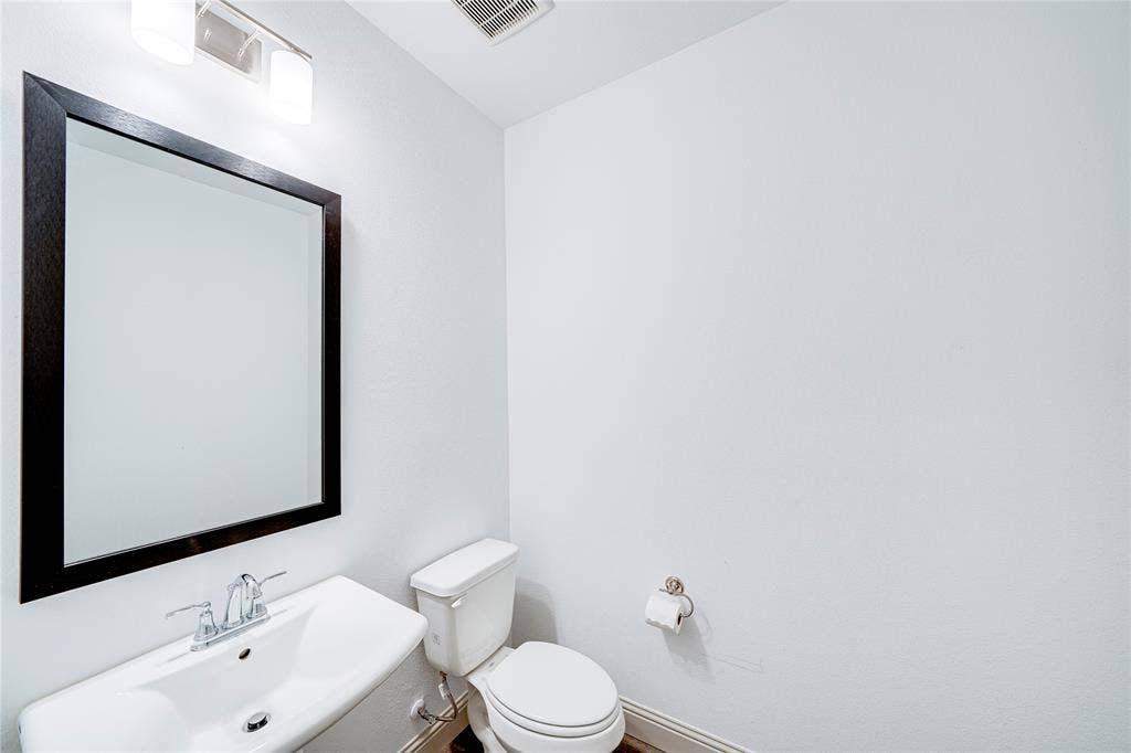 8888 Samara Street, Frisco, TX 75035 Wall-mounted vanity with a rectangular sink, chrome faucet, and framed mirror