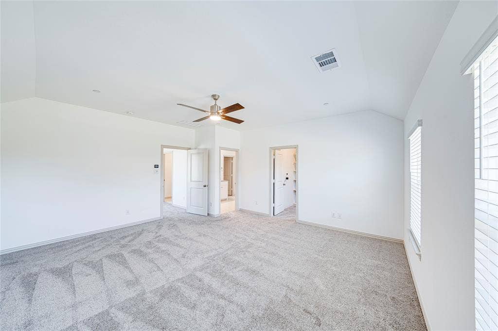 8888 Samara Street, Frisco, TX 75035 Vaulted ceiling with a contemporary ceiling fan, light-toned carpeting, multiple windows with blinds, and white interior doors