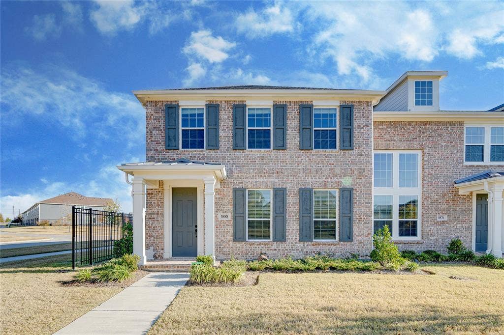 8888 Samara Street, Frisco, TX 75035 Brick exterior with contrasting dark shutters, covered entry with columns, and a dormer window