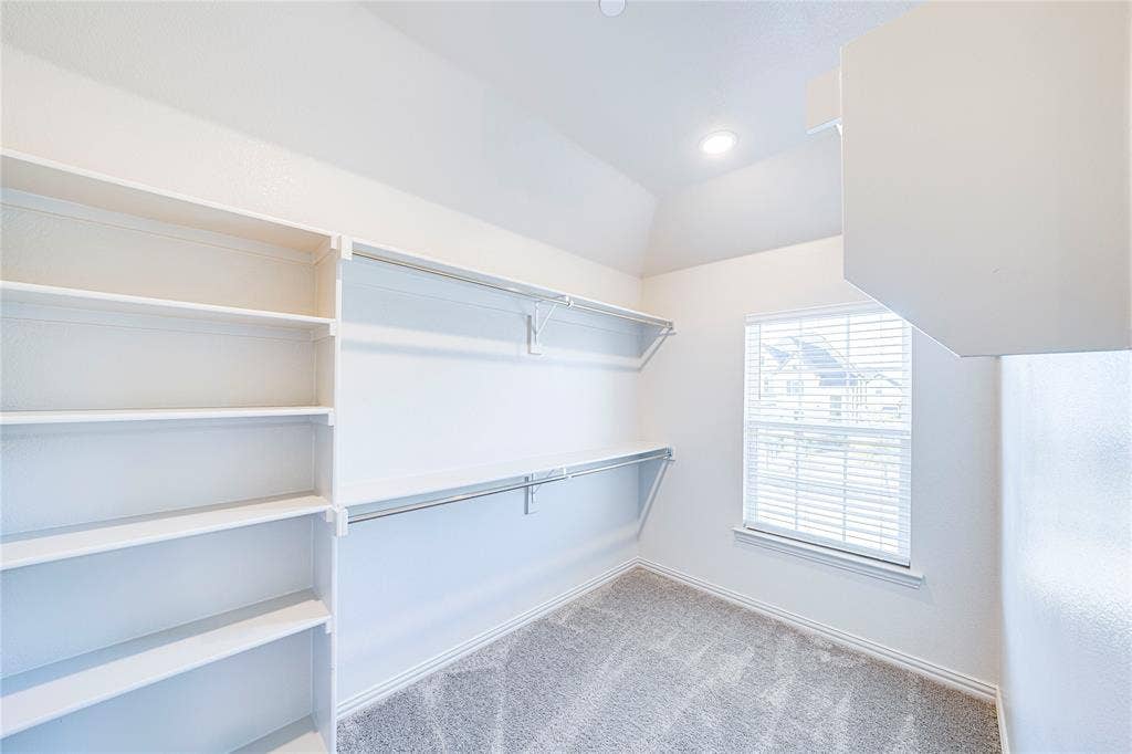8888 Samara Street, Frisco, TX 75035 Walk-in closet with built-in shelving, hanging rods, and a window with blinds