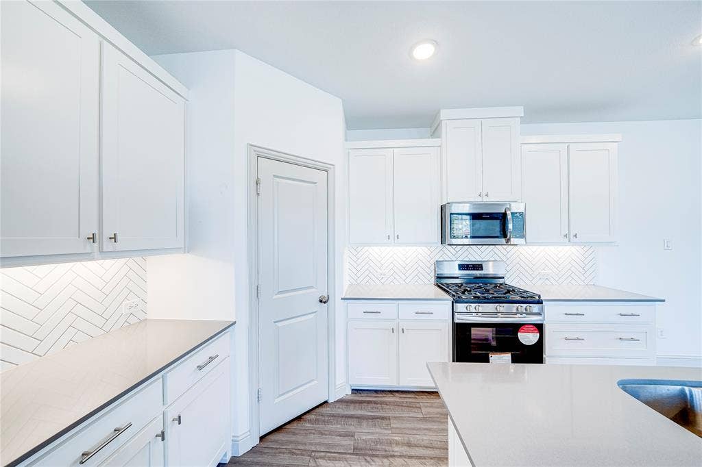 8888 Samara Street, Frisco, TX 75035 White shaker-style cabinetry with matte silver hardware