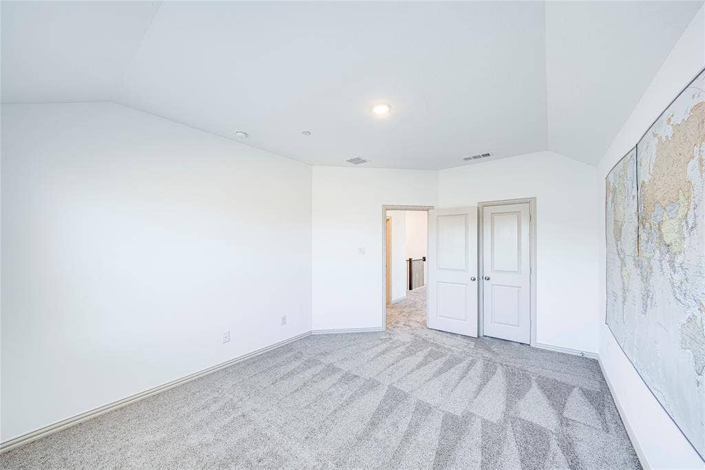 8888 Samara Street, Frisco, TX 75035 Vaulted ceiling, recessed lighting, neutral tone carpeting, white panel doors, and bright white wall finishes