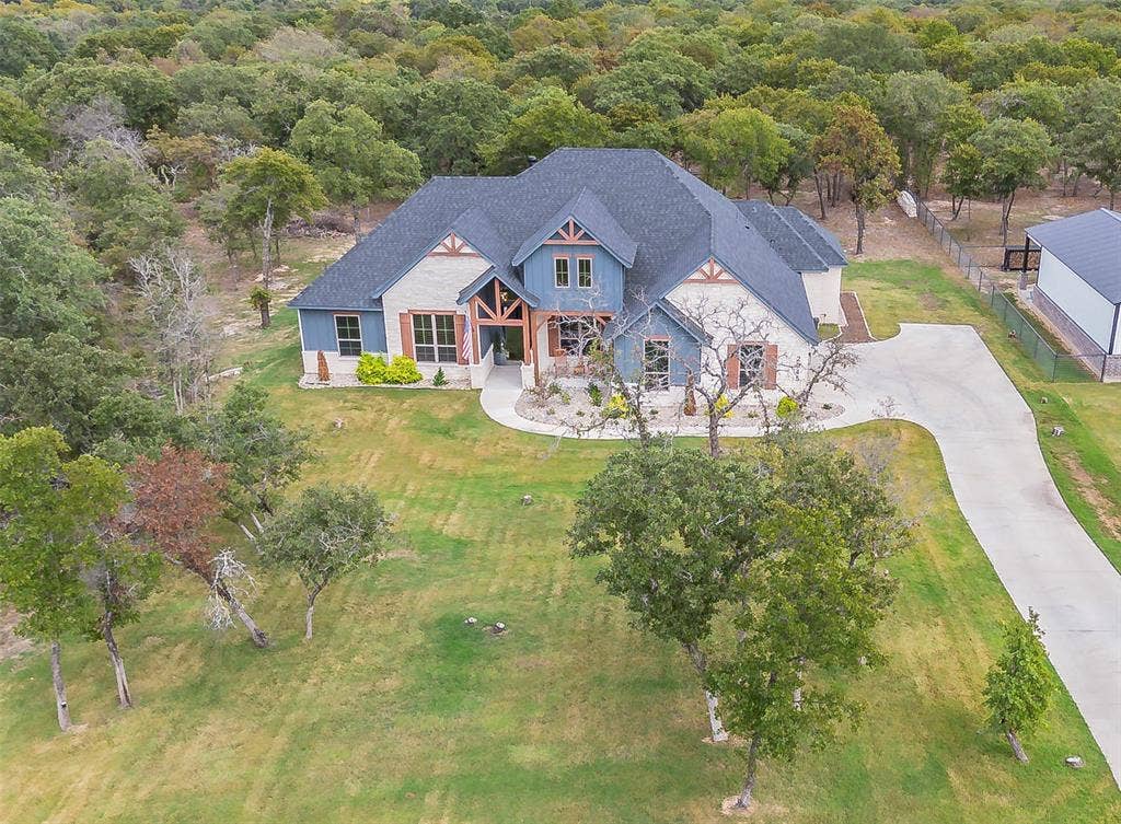 Look at all of the details on this home that is surrounded by so many trees! Extra parking at the top of the driveway.